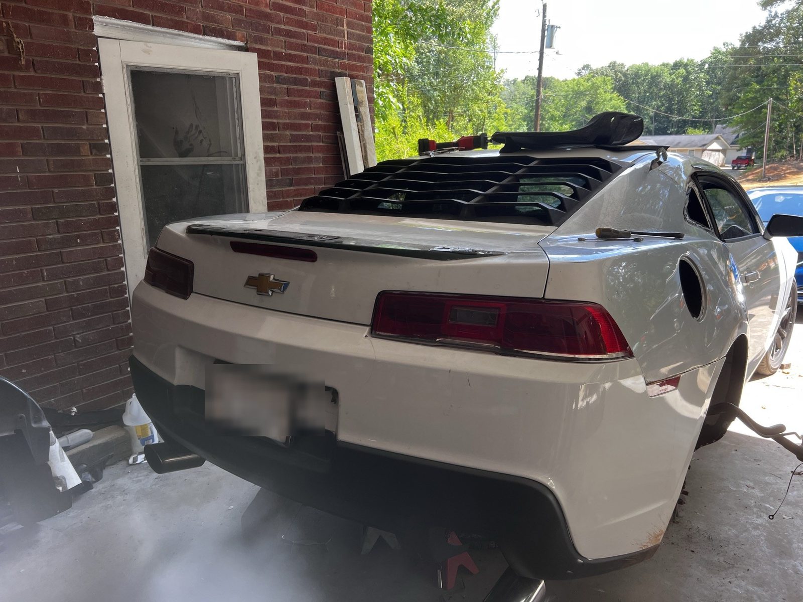White Chevrolet Camaro after rear collision repair and refinishing at J&J Automotive Repair