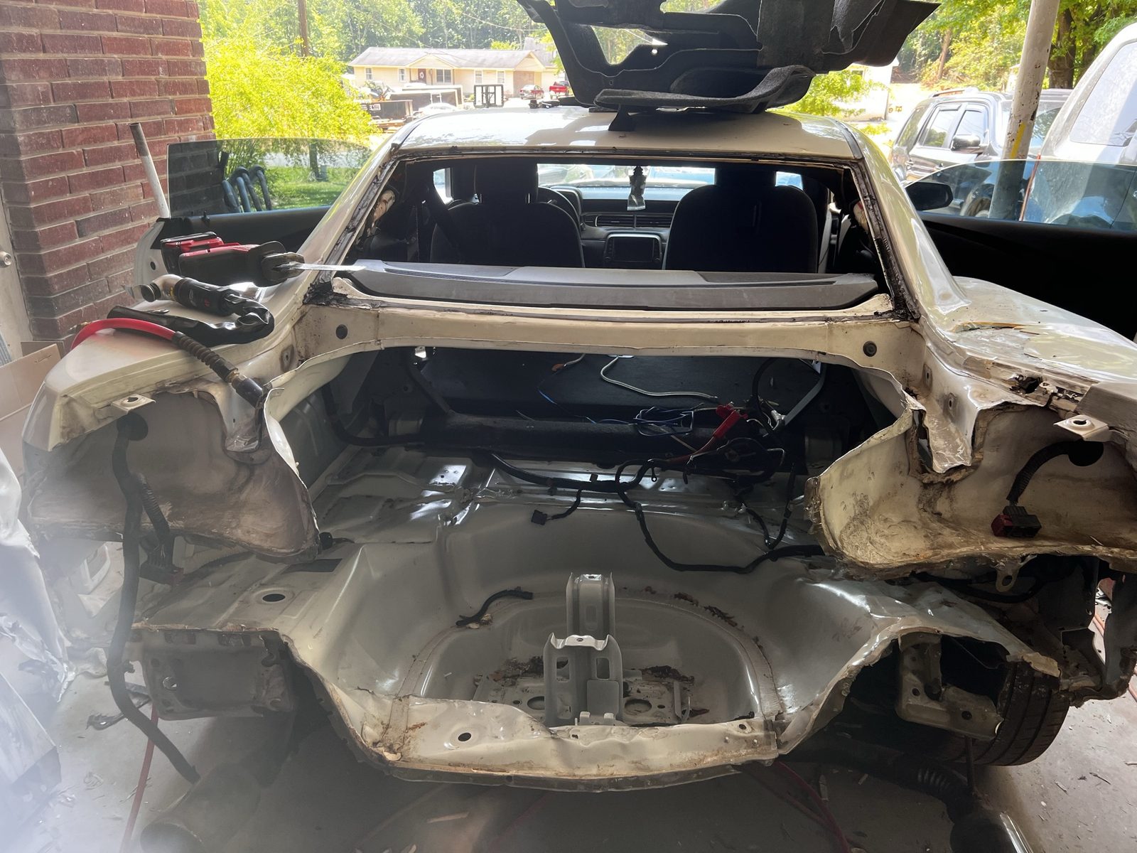 Rear collision damage on a white Chevrolet Camaro before repair at J&J Automotive Repair