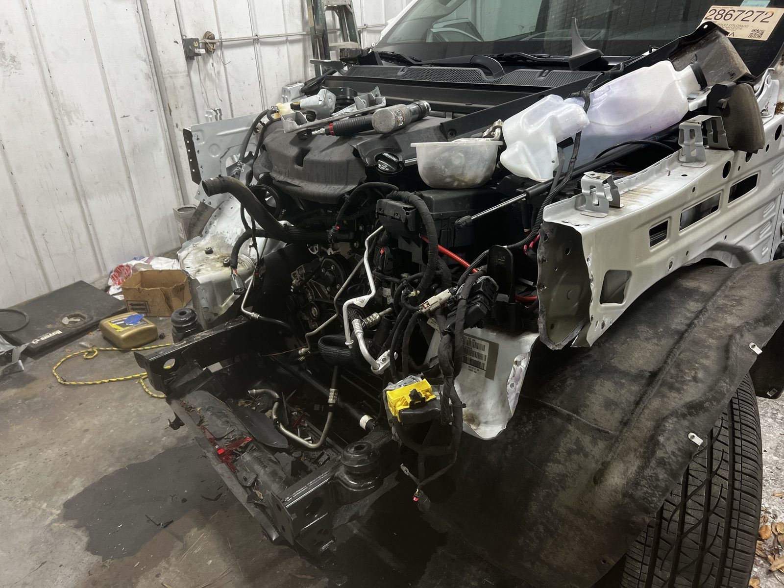 Vehicle with the front end disassembled for repair inside J&J Automotive Repair